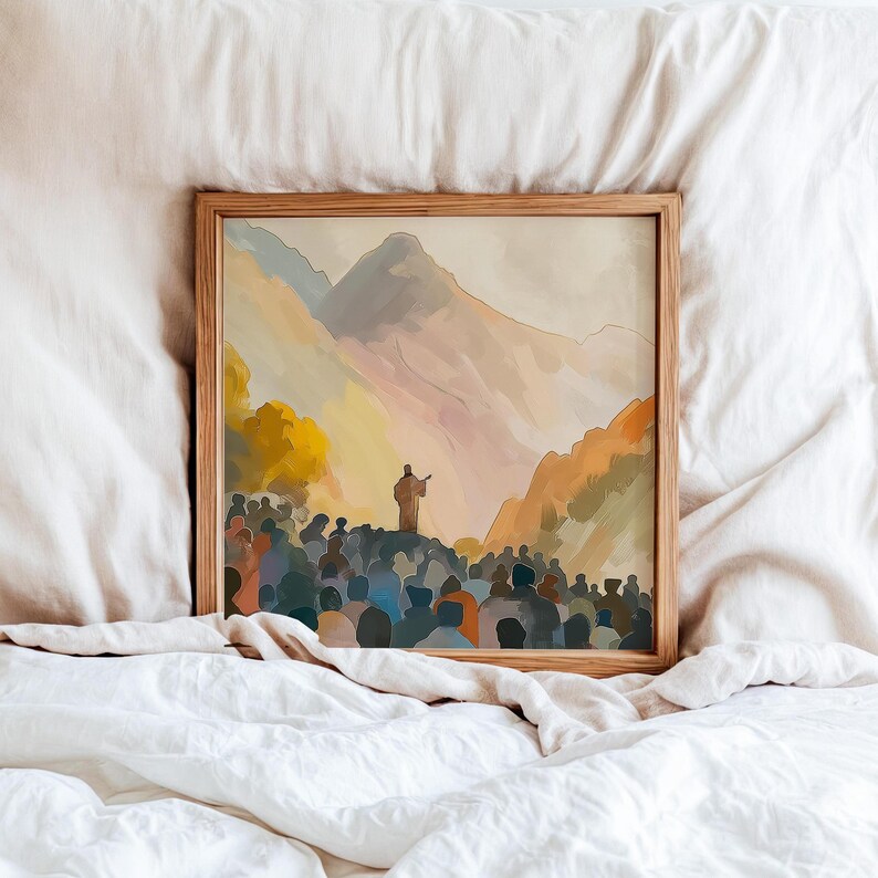 May include: A framed art print showing a crowd of people gathered before a figure on a hill, with mountains in the background. The artwork uses a warm colour palette of oranges, yellows, and blues, creating a serene and contemplative scene.
