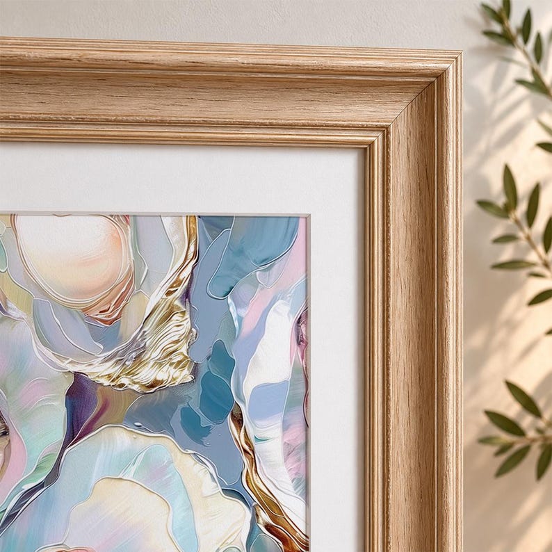 May include: Abstract art print in a light wood frame. The artwork features a colorful, flowing design with shades of blue, pink, gold, and white. The frame is a light, natural wood color, and the print is matted with a white border.