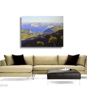 May include: A painting of a landscape with a blue sky and green hills. The hills are covered in trees and there are some mountains in the distance.