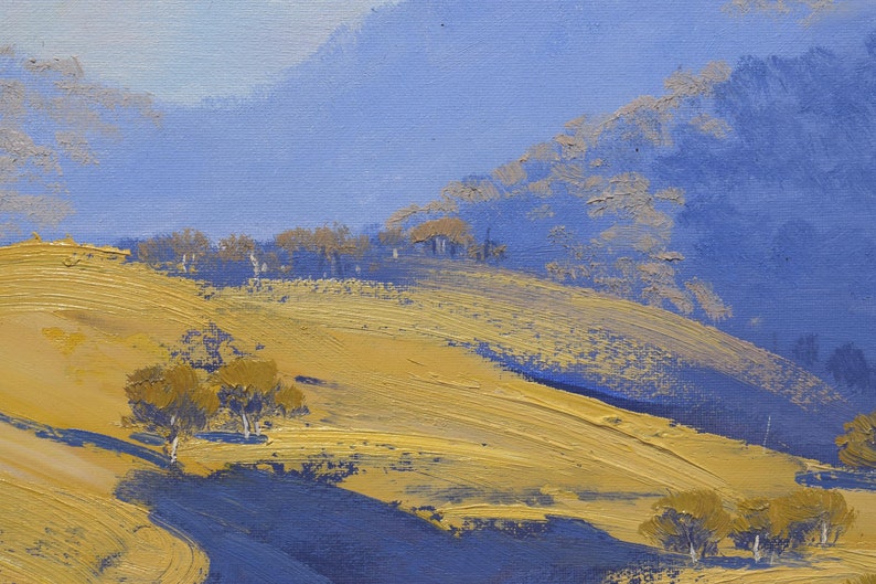 May include: A painting of a landscape with rolling hills and trees. The hills are painted in shades of yellow and brown, while the trees are painted in shades of blue and green. The sky is a light blue color.