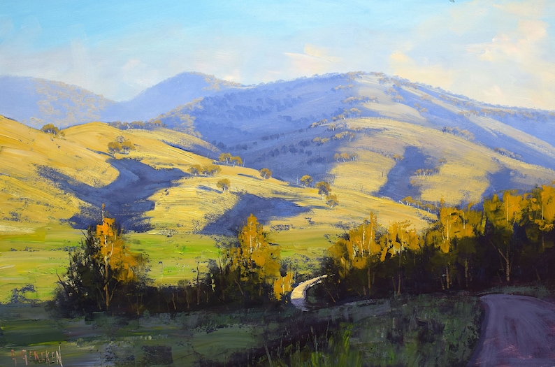 May include: A painting of a winding road leading through a valley with rolling hills and a blue sky. The hills are covered in green grass and trees. The road is surrounded by trees and bushes.