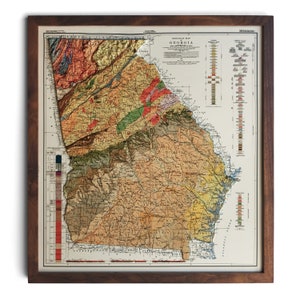 May include: A vintage geological map of Georgia, showing the state's different rock formations in various colors. The map includes a key with color-coded descriptions of the different geological formations. The map is framed in a dark wood frame.