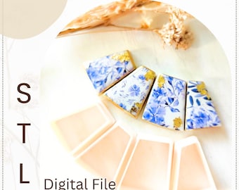 May include: An overhead shot displays a collection of digital files. The files are in the shape of a trapezoid, with a light peach color. Some files are decorated with a blue floral pattern and gold accents. The text "STL" and "Digital File" are visible.