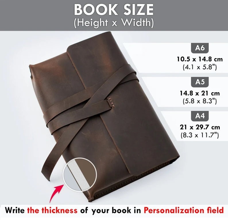May include: A brown leather book cover with a strap closure. The cover is designed to fit a book with dimensions of 10.5 inches by 14.8 inches, 14.8 inches by 21 inches, or 21 inches by 29.7 inches. The text "Write the thickness of your book in Personalization field" is visible at the bottom of the image.