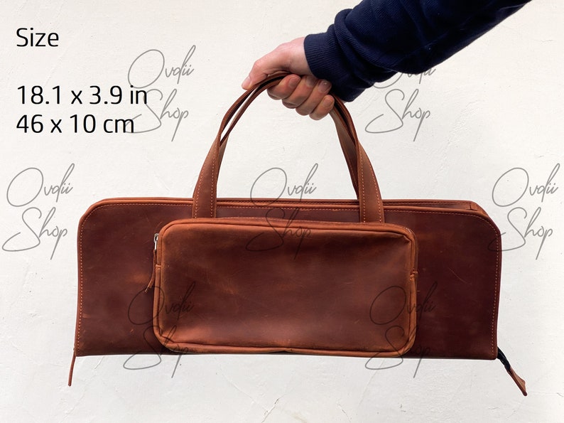 May include: A brown leather carrying case with a zippered pocket and a handle. The case measures 18.1 inches by 3.9 inches or 46 cm by 10 cm.