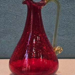 May include: A set of three ceramic mugs with a speckled, matte finish. The mugs are in shades of cream, light gray, and dark gray. Each mug has a simple, minimalist design, perfect for coffee or tea.