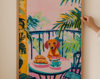 May include: A painting of a dachshund sitting at a table with a cup of coffee and croissants on a pink and green background. The dog is looking at the viewer. The painting is framed in a light wood frame.