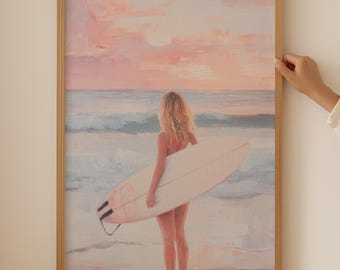 May include: A framed painting of a person standing on a beach holding a surfboard. The person is facing away from the viewer and the background is a pink and orange sunset over the ocean.