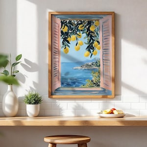 a framed painting of a scenic view of the sea with a lemon tree in the foreground, hanging on a white wall above a wooden shelf with a bowl of fruit and a potted plant.