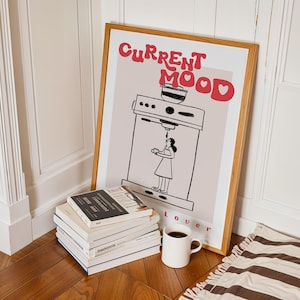 a pile of books sitting next to a poster