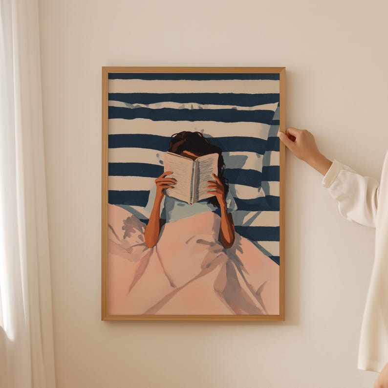 A person is sitting in bed, reading a book.