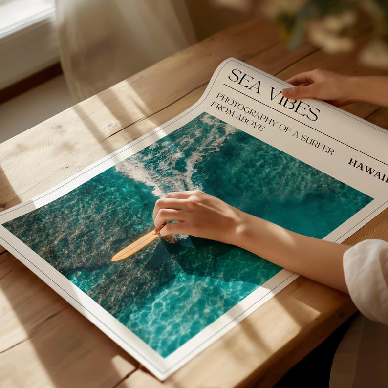 May include: A poster with the text "Sea Vibes" and "Photography of a surfer from above Hawaii". The poster features a photo of a surfboard in the ocean with turquoise water and white waves.