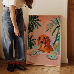 a woman standing next to a painting of a dog
