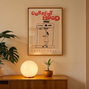 a picture of a coffee maker on a wall next to a potted plant