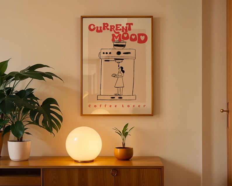 a picture of a coffee maker on a wall next to a potted plant