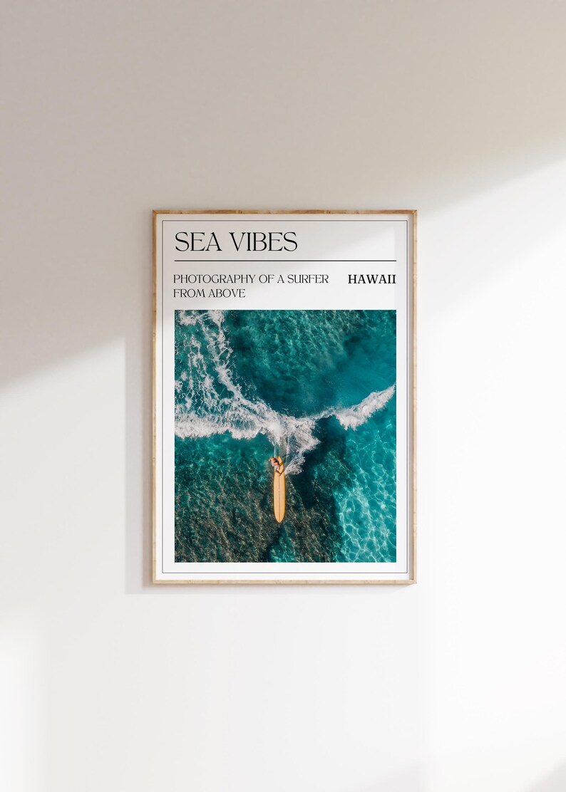 a poster hanging on the wall above a surfboard