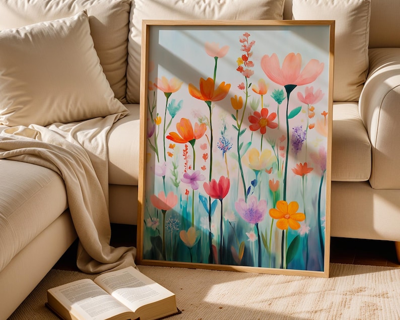 a painting of flowers on a canvas next to an open book