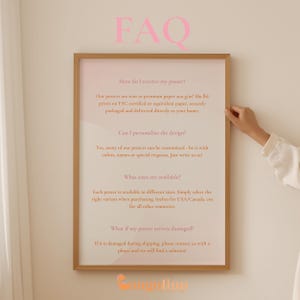 a person holding up a framed poster with the words faq on it