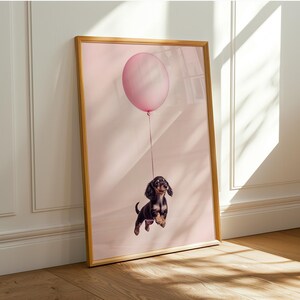 a picture of a dachshund holding a balloon