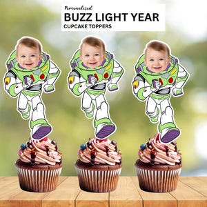 May include: Three cupcakes with chocolate frosting, each topped with a Buzz Lightyear-themed image of a baby. The image is a cutout of the character's spacesuit. The text at the top reads "Personalized Buzz Lightyear Cupcake Toppers."