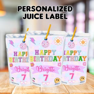 May include: Three pink and white juice box labels with a rainbow background. The labels feature a disco ball, a lightning bolt, a smiley face, a flower, and the text "Happy Birthday" in rainbow colors. The name "Brigitte" and the number "7" are written in pink. The labels are designed for a 200 ml juice box.