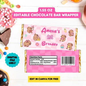 May include: Pink and white chocolate bar wrapper with a capybara cartoon design. The wrapper says "Amelia's 1st Birthday" and has a nutrition facts label that says "Love 100%, Family & Friends 100%, Happiness & Joy 100%, Hug & Kisses 100%".