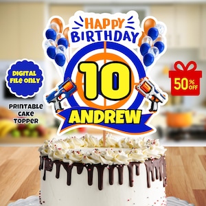 May include: Printable cake topper featuring a blue and orange target with the number 10 in yellow, the name Andrew, and two blue and orange toy guns. The text "Happy Birthday" is above the target and the text "50% Off" is in a red box.