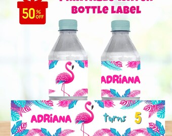 May include: Printable water bottle labels featuring a pink flamingo design. The labels include the name "Adriana" and the number "5". The design incorporates tropical leaves in shades of blue and pink. The text "Digital File Only" is also present.