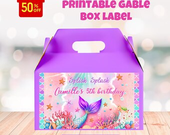 May include: A purple gable box with a handle, featuring a mermaid-themed label. The label includes the text "Splish Splash Camille's 5th birthday" with a mermaid tail illustration. The box also has a "50% OFF" gift tag and the words "Printable Gable Box Label."
