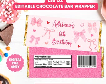 May include: Pink and white printable chocolate bar wrapper with a gold border. The wrapper features a pink glitter background with white bows and hearts. The text on the wrapper reads "Adriana's 6th Birthday".