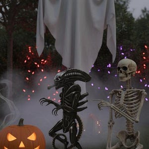 May include: A Halloween scene featuring a carved pumpkin with a glowing face, a white ghost, a black alien figure, and a skeleton. The scene is set outdoors with colorful lights and fog.