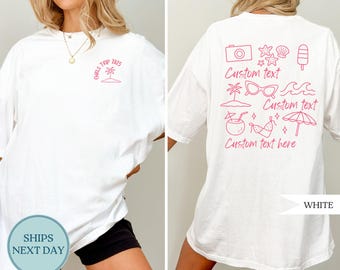 May include: White t-shirt with a pink graphic on the front that says "Girls Trip 2025". The back of the shirt has pink illustrations of a camera, seashells, sunglasses, and other beach-themed images with the words "Custom text".