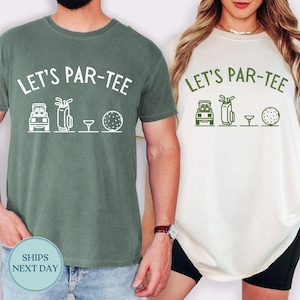 May include: Two t-shirts, one green and one cream, each with the text "LET'S PAR-TEE" above golf-themed graphics. The graphics include a golf cart, golf bag, tee, and golf ball. The green shirt has white graphics, while the cream shirt has green graphics.