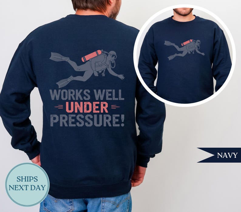 Navy sweatshirt with a graphic of a scuba diver and the text "WORKS WELL UNDER PRESSURE!"