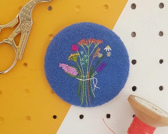 blue embroidered floral badge