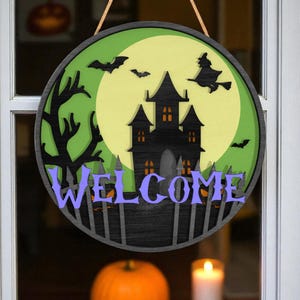 Halloween Door Hanger | Haunted House with Witch and Bats | Spooky Welcome Sign with Full Moon | Round Wooden Halloween Porch Decor