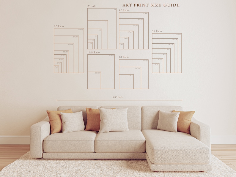 May include: An art print size guide with various aspect ratios and dimensions is displayed on a wall. A beige sofa with throw pillows sits below the guide. The text "ART PRINT SIZE GUIDE" is visible.