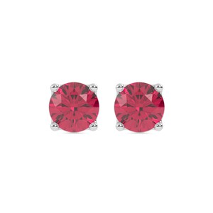 May include: A pair of stud earrings featuring round, faceted, deep pink gemstones set in four-prong silver metal settings. The stones exhibit a brilliant cut with multiple facets that reflect light, creating a vibrant and uniform color throughout.
