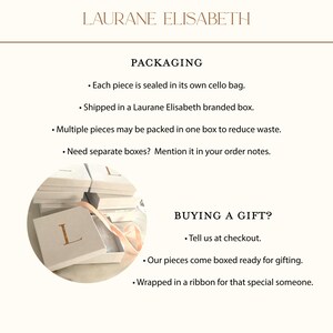a collection of white gift boxes with a pink ribbon, suggesting they are ready to be packaged and sent as gifts.