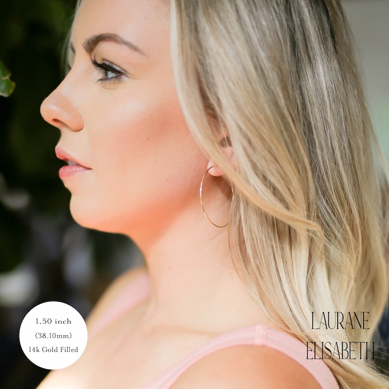 model wearing 1.50 inch 14k gold filled thin hoop earrings.  threader earrings. Laurane Elisabeth specializing in delicate, lightweight handmade, minimalist earring designs available in 14k gold filled, 14k rose gold filled and 925 sterling silver. nickel free threader earrings.