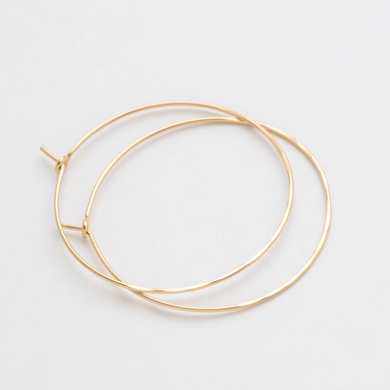 2 inch 14k gold filled hoop earrings. bottom half hammered close up. Laurane Elisabeth specializing in delicate, lightweight minimalist jewelry. Always nickel free.