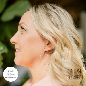 model wearing 2 inch 14k gold filled thin hoop earrings.  threader earrings. Laurane Elisabeth specializing in delicate, lightweight handmade, minimalist earring designs available in 14k gold filled, 14k rose gold filled and 925 sterling silver. nickel free threader earrings.