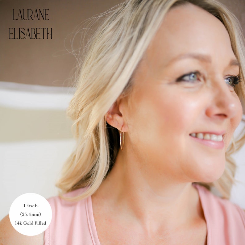 model wearing 1 inch 14k gold filled thin hoop earrings.  threader earrings. Laurane Elisabeth specializing in delicate, lightweight handmade, minimalist earring designs available in 14k gold filled, 14k rose gold filled and 925 sterling silver. nickel free threader earrings.