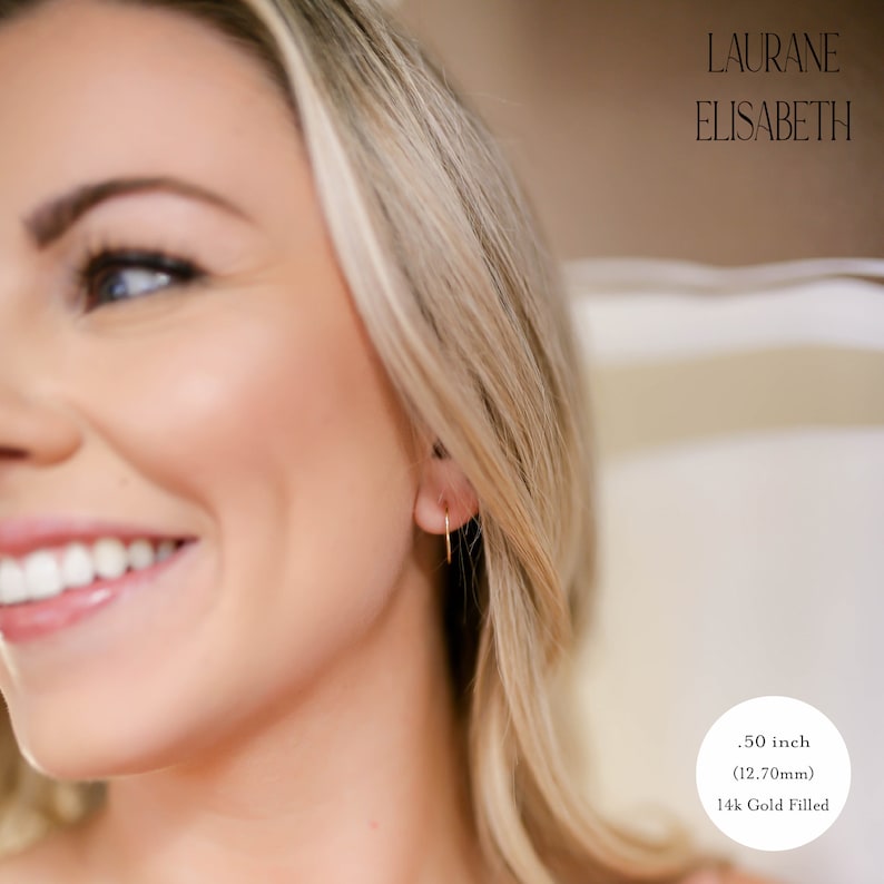 model wearing .50 inch 14k gold filled thin hoop earrings.  threader earrings. Laurane Elisabeth specializing in delicate, lightweight handmade, minimalist earring designs available in 14k gold filled, 14k rose gold filled and 925 sterling silver. nickel free threader earrings.