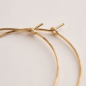 14k gold filled hoop earrings. close up of full hoop hammering. threader hoop earrings. Laurane Elisabeth specializing in delicate, lightweight minimalist jewelry. Always nickel free.