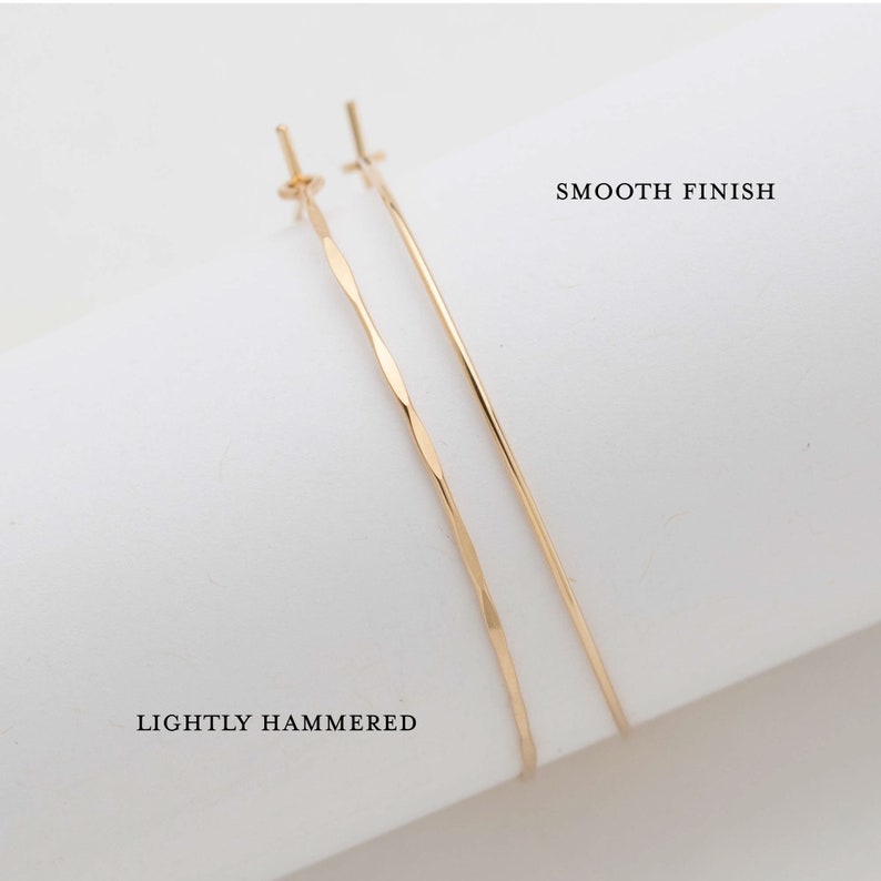 14k gold filled thin hoop earrings showing a side by side example of available lightly hammered and smooth finishes. Laurane Elisabeth specializing in delicate, lightweight handmade, minimalist earring designs available in 14k gold filled, 14k rose gold filled and 925 sterling silver. nickel free threader earrings.