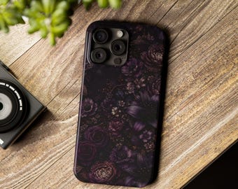 May include: A rectangular smartphone case featuring a dark, moody floral pattern with deep purple, black, and violet roses and blossoms. The case has a cutout for a triple-lens camera system and a flash, covering the back of the device.