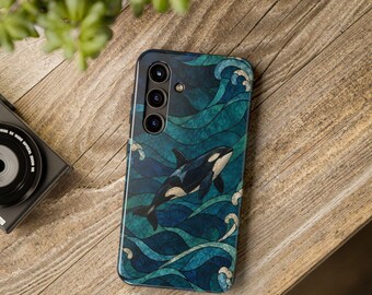 May include: A smartphone case featuring a black and white orca swimming through stylized deep blue and teal ocean waves. The design has a stained glass aesthetic with dark outlines separating the various shades of blue and green water.