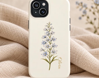 May include: A cream-colored smartphone case featuring a vertical illustration of a light blue delphinium flower with green stems and leaves. The name Olivia is printed in a gold cursive script to the right of the flower stem.