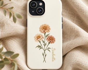 May include: A cream-colored smartphone case featuring a botanical illustration of three marigold flowers in shades of orange and peach with green stems. The name Isabella is printed in a gold cursive script to the right of the flowers.